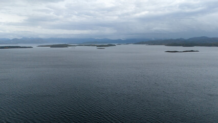 Serene Water View with Islands and Cloudy Sky
