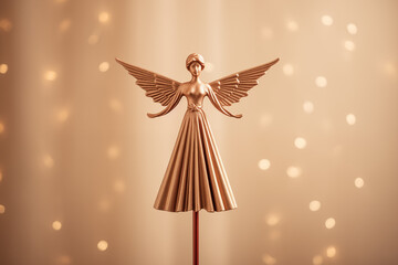 A stunning bronze angel figurine with delicate wings against a softly blurred golden background, perfect for capturing attention and adding elegance to any space.