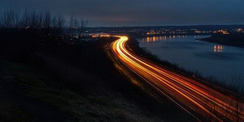 Obraz premium Nighttime river highway light trails