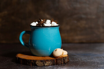 hot chocolate with spices and marshmallows on a dark background