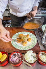 Chef plating a Scallop dinner