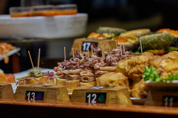 Selection of traditional Basque pinchos, arranged on baguette slices with different toppings