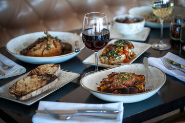 Italian dishes on table with wine