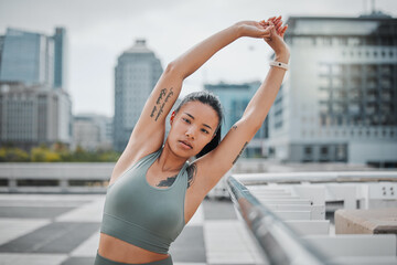 Portrait, stretching and woman in city, training or workout routine with warm up. Face, runner or healthy athlete with wellness, New York or buildings with urban town, exercise or sports with fitness