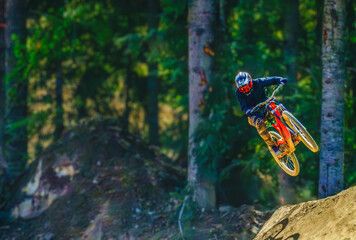 Mountain biker taking a leap of faith at Whistler, BC.