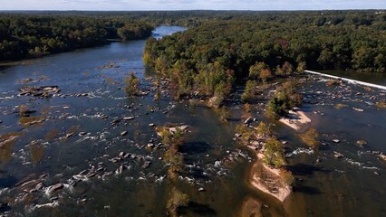 Natural river flowing around rocks and stones in afternoon sunshine Jame River Richmond, VA