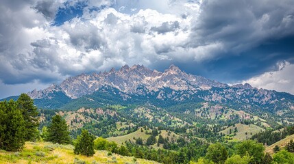 Obraz premium Majestic mountain landscape under a dramatic sky with greenery below.