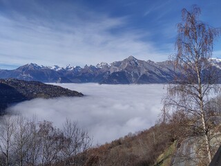 view on misty valley in the Swiss alps