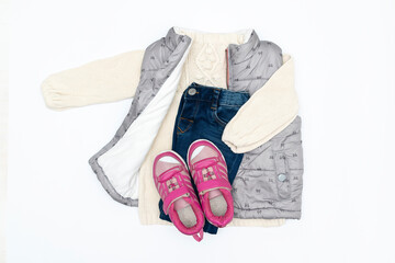 Vest,warm jumper,sweater,jeans pants,sneakers.Set of baby children's clothes,clothing for spring,autumn,winter.Fashion girls kids outfit.Flat lay,top view