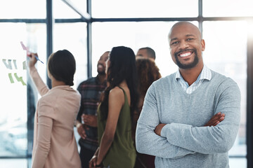 Obraz premium Group, smile and man with arms crossed, office and planning for project, glass and reading of ideas, sticky notes and teamwork. Proud, creative and people with strategy, ux designer and meeting