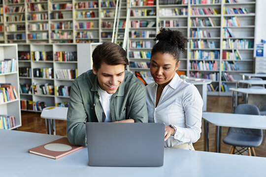 A young teacher passionately educates her student amid a library filled with books and knowledge. - Powered by Adobe