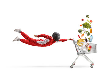 Racer in a red suit and black helmet flying with a shopping cart and falling groceries