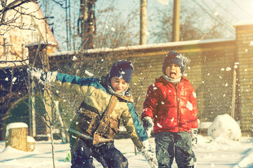 Two boys play with snow. Happy childhood. Brothers on a walk. two kids playing with snow. toned