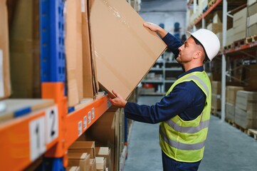 portrait of a smiling young warehouse worker working in a cash and carry wholesale store