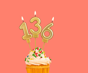 Birthday number 136 - Golden candle with cupcake