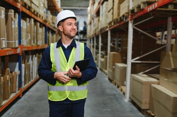 Portrait of warehouseman with clipboard checking delivery, stock in warehouse