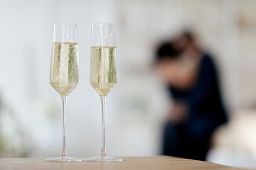 Glasses of champagne and candles on restaurant table, afro couple having romantic date. High quality photo