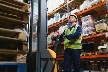 Storehouse manager supervising the lift truck operator