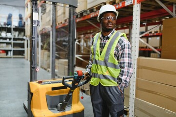 african american Storehouse manager supervising the lift truck operator