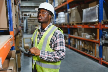 portrait of a young african american warehouse worker working in a cash and carry wholesale store