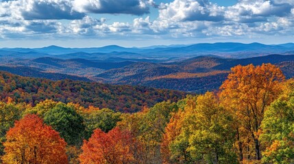 A panoramic view of a mountain range with vibrant fall foliage.