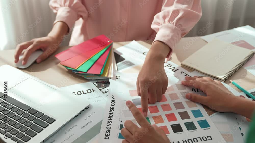 Poster slow motion hand closeup of two designer brainstorming and choosing color for graphic design working