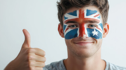Young man celebrating australian pride with face paint and thumbs up gesture
