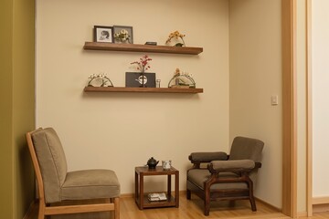 Cozy minimalist living space with modern wooden furniture and elegant wall decor.