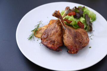 Duck leg confit with sauce. isolate in white background. top view. Duck confit on white plate