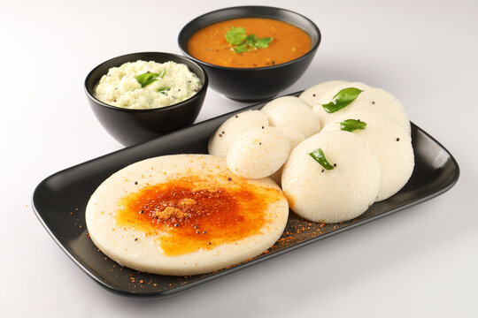 Thatte idli or Plate idly with sambar coconut chutney, chutney podi popular breakfast of Kerala South India Sri Lanka. Healthy steamed rice cakes steaming