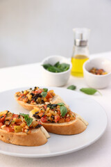 Bruschetta with Tomato and Basil Traditional toasted Italian food tomato bruschetta seasoned with spice and garnished with basil