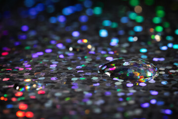Water drop on sparkly background