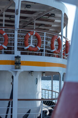 A view from below of lifebuoys lined up on a cruise ship, selective focus.