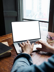 Close up of male hands and laptop with blank screen. Mock-up of computer monitor.