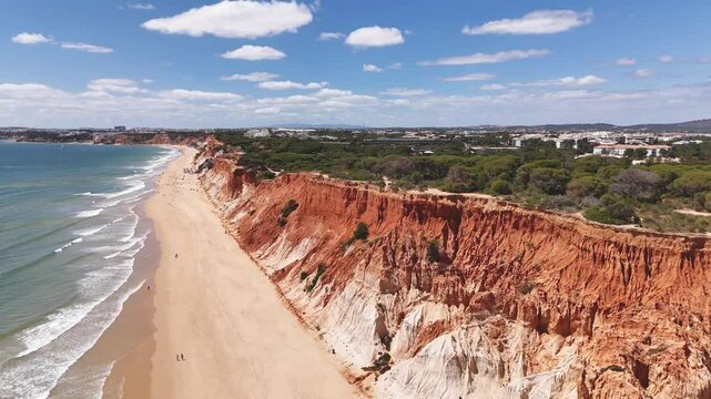 Famous beach Praia da Falesia with red-colored cliffs in springtime. Albufeira region, Portugal