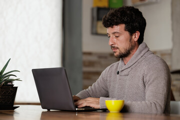 businessman working on his computer while drinking specialty coffee in the office