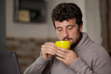 Man enjoying a cup of coffee on break from work.