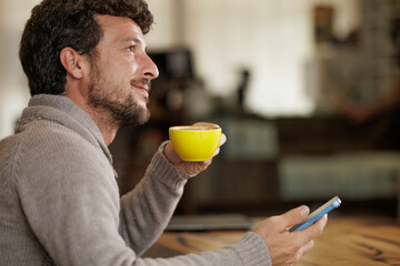 Businessman working with his computer while drinking a specialty coffee to have energy and clear his mind to make decisions in the company.