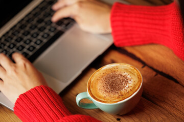 Businesswoman working with her laptop in a cafe while enjoying a coffee. She checks work emails, notifications to schedule meetings. Cafeteria, boss or university student, person with computer.