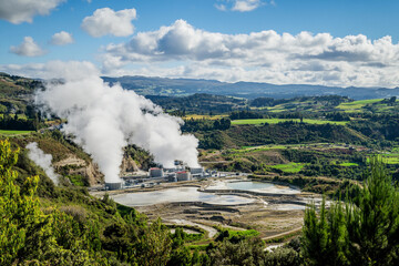 Geothermal power plant steaming in scenic New Zealand landscape