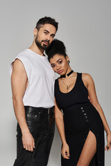 A couple exudes love and confidence, sharing an intimate moment in a chic, minimalist environment.