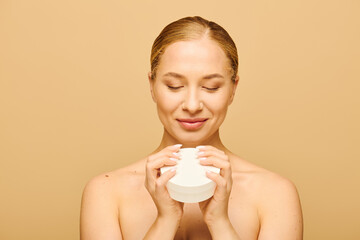 The young woman closes her eyes, savoring the soothing aroma of her skincare product.