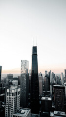 Fototapeta premium tall black skyscraper dominates a cityscape