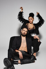 A passionate couple poses elegantly, showcasing their deep connection and style.