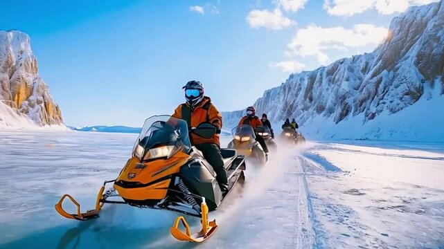 Tourists ride snowmobiles on the frozen Baikal Lake in winter