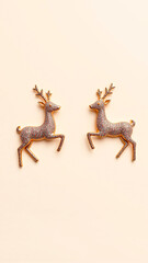 Obraz premium two glittering golden deer figurines on a peach background