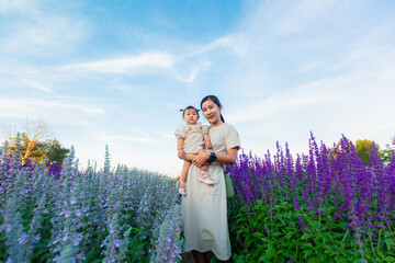 Mother and child in the flower field,mother and little daughter in a flowering lavender field enjoying her scent