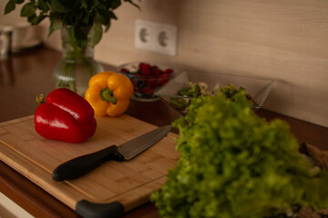 A wooden kitchen counter with fresh vegetables