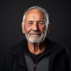 Obraz premium Close up of an elderly man with a beard in a casual flannel shirt on a neutral gray backdrop