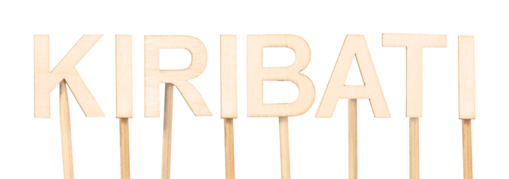 Wooden letters mounted on sticks spelling the word Kiribati. Country in Oceania. - Powered by Adobe